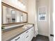 Bathroom with a large mirror, gray countertops, white cabinets, and tile floors at 5865 Egan Crest Dr, Las Vegas, NV 89149