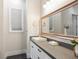 Bathroom featuring a vanity with gray countertops, white cabinets, carpet floors and a large mirror at 5865 Egan Crest Dr, Las Vegas, NV 89149