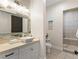 Stylish bathroom features a modern vanity, decorative mirror, and tiled shower with seating at 5865 Egan Crest Dr, Las Vegas, NV 89149