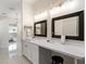 Bright bathroom with marble floors, a makeup vanity area, and double sinks at 5865 Egan Crest Dr, Las Vegas, NV 89149