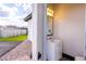 The bathroom features a mirror, sink, cabinet, with a view of the back yard and a grassy area at 5865 Egan Crest Dr, Las Vegas, NV 89149