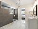 Spacious bathroom featuring marble floors, a walk-in shower with bench, and a double vanity with modern fixtures at 5865 Egan Crest Dr, Las Vegas, NV 89149
