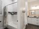 This bathroom features a shower with white subway tile and a vanity with white cabinets at 5865 Egan Crest Dr, Las Vegas, NV 89149