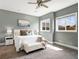 Bright bedroom featuring a king bed, and windows providing a sun-filled interior at 5865 Egan Crest Dr, Las Vegas, NV 89149