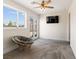 Bedroom with carpet floors, a ceiling fan, and a rattan chair near the glass patio doors at 5865 Egan Crest Dr, Las Vegas, NV 89149