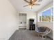 This bedroom features carpet floors, a ceiling fan, an arcade game and a wicker chair at 5865 Egan Crest Dr, Las Vegas, NV 89149