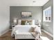 Serene bedroom featuring a king bed, soft lighting, and a cozy bench, creating a relaxing retreat at 5865 Egan Crest Dr, Las Vegas, NV 89149
