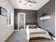 Gray bedroom offers a ceiling fan, carpet floors and a view to an attached bathroom at 5865 Egan Crest Dr, Las Vegas, NV 89149
