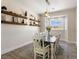 This dining room showcases floating wood shelves, a modern light fixture and a gray area rug at 5865 Egan Crest Dr, Las Vegas, NV 89149