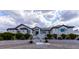 Elegant home exterior featuring manicured landscaping, stone accents, and a welcoming entrance with a paved walkway and stairs at 5865 Egan Crest Dr, Las Vegas, NV 89149