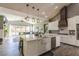 Bright, modern kitchen with a large island, farmhouse sink, and stainless steel appliances at 5865 Egan Crest Dr, Las Vegas, NV 89149
