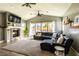 Spacious living room with fireplace, TV, and large sectional sofa perfect for entertaining at 5865 Egan Crest Dr, Las Vegas, NV 89149