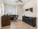 Well-lit office with built-in desk, storage cabinet, and wood-look tile flooring at 5865 Egan Crest Dr, Las Vegas, NV 89149