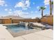 Stunning backyard pool area with palm trees, a waterfall feature, and privacy fencing at 5865 Egan Crest Dr, Las Vegas, NV 89149