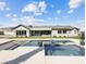 A luxurious pool and backyard with modern design and inviting patio space with a view of the rear exterior of the home at 5865 Egan Crest Dr, Las Vegas, NV 89149