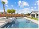 Backyard pool with spa, waterfall, green grass and outdoor landscape at 5865 Egan Crest Dr, Las Vegas, NV 89149