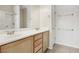 The bathroom boasts a double sink vanity with wood cabinets, and a shower and tub at 6059 Wheat Penny Ave, Las Vegas, NV 89122
