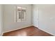 Inviting bedroom with wood-look floors, a window, and standard door at 6059 Wheat Penny Ave, Las Vegas, NV 89122