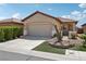 Inviting home featuring a manicured yard, two-car garage, and charming curb appeal at 6059 Wheat Penny Ave, Las Vegas, NV 89122
