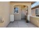 A close-up of the entryway showcases an arched entrance and unique door with a security screen at 6059 Wheat Penny Ave, Las Vegas, NV 89122