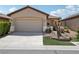 Charming single-story home featuring a two-car garage, landscaped front yard, and well-maintained exterior at 6059 Wheat Penny Ave, Las Vegas, NV 89122
