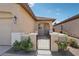 A charming front porch provides a welcoming entrance to the home, complete with a gated courtyard at 6059 Wheat Penny Ave, Las Vegas, NV 89122