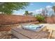 Relaxing hot tub surrounded by a brick wall, offering privacy and a serene outdoor experience at 6059 Wheat Penny Ave, Las Vegas, NV 89122