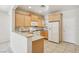 Bright kitchen features light wood cabinetry, complete with white appliances and a tile backsplash at 6059 Wheat Penny Ave, Las Vegas, NV 89122