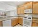Kitchen with tile floors, lots of light wood cabinets, and white appliances, for a clean and organized space at 6059 Wheat Penny Ave, Las Vegas, NV 89122