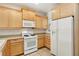 Spacious kitchen boasts tile floors, light wood cabinets, and white appliances, creating a bright atmosphere at 6059 Wheat Penny Ave, Las Vegas, NV 89122