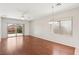 Spacious living room with wood floors, a ceiling fan, and access to the outdoor patio at 6059 Wheat Penny Ave, Las Vegas, NV 89122