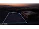 Aerial view of a vacant lot showcasing city lights and mountain views at night at 611 Grand Rim Dr, Henderson, NV 89012