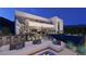 Modern backyard with a pool, lounge area, outdoor bar and spiral staircase to upper balcony at 611 Grand Rim Dr, Henderson, NV 89012