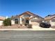 Charming single-story home with a well-manicured lawn and a two-car garage at 632 Hitchen Post Dr, Henderson, NV 89011