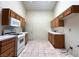 Functional kitchen with white appliances and tile flooring at 632 Hitchen Post Dr, Henderson, NV 89011