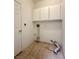 Utility room with tile floor and cabinets; washer and dryer hookups at 632 Hitchen Post Dr, Henderson, NV 89011