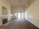 Cozy living room features a fireplace, ceiling fan and carpeted flooring at 632 Hitchen Post Dr, Henderson, NV 89011