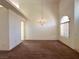 Open living area featuring soaring ceilings and a hanging light fixture at 632 Hitchen Post Dr, Henderson, NV 89011