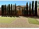 Backyard featuring low maintenance landscaping with artificial turf, trees, and a gravel area at 7253 Blooming Jasmine Ave, Las Vegas, NV 89117