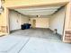 Spacious garage with concrete flooring, overhead lighting, and ample space for parking and storage at 7253 Blooming Jasmine Ave, Las Vegas, NV 89117