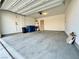 Spacious garage with concrete flooring, overhead lighting, and ample space for parking and storage at 7253 Blooming Jasmine Ave, Las Vegas, NV 89117