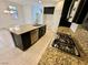 Gourmet kitchen with stainless steel appliances, dark cabinets, and granite countertops at 7253 Blooming Jasmine Ave, Las Vegas, NV 89117