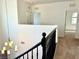 Upstairs landing featuring a decorative chandelier, black railing and carpeted floors at 7253 Blooming Jasmine Ave, Las Vegas, NV 89117