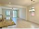 Spacious, open-concept living area with tile floors and natural light throughout at 7253 Blooming Jasmine Ave, Las Vegas, NV 89117