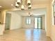 Bright and airy open living space with tile flooring and a view of the kitchen at 7253 Blooming Jasmine Ave, Las Vegas, NV 89117