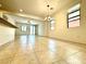 Open floor plan with tile flooring, ample natural light, and a view of the dining area at 7253 Blooming Jasmine Ave, Las Vegas, NV 89117