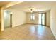A bright living room with tile floors, a ceiling fan, and access to the backyard at 7253 Blooming Jasmine Ave, Las Vegas, NV 89117