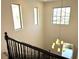 A view from the top of the staircase with the chandelier on display at 7253 Blooming Jasmine Ave, Las Vegas, NV 89117