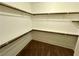 Spacious walk-in closet with carpeted floor and built-in shelving and racks for organized storage at 7253 Blooming Jasmine Ave, Las Vegas, NV 89117