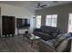 Inviting living room with a ceiling fan, a comfortable leather sofa, and large windows for natural light at 7334 N Decatur Blvd # 6, Las Vegas, NV 89131